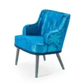 Turquoise armchair with floral paisley upholstery, curved high back, rounded armrests, and gray iridescent wood legs against white backdrop.