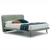 Corolle bed base, sage green upholstery, rectangular headboard with diamond quilting, burnt orange and teal velvet pillows.