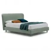 King bed with sage green upholstery, rectangular diamond-quilted headboard, teal velvet and burnt orange pillows, and textured teal throw blanket.