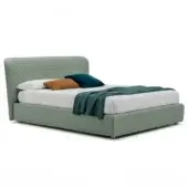 Adjustable bed “corolle – h.29” with sage green quilted upholstery, dark gray base, white duvet, blue throw, orange & teal velvet pillows.