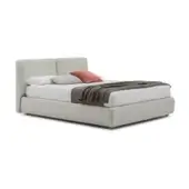 Bed base, light beige upholstered headboard, low platform with dark gray legs, white duvet, gray throw, terracotta pillow.