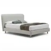 Gray upholstered bed with curved headboard, white bedding, and tapered legs; product label reads “karol – h.20 base”.
