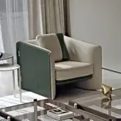 Superior Turri Blossom lounge chair with light beige textile and dark green leather upholstery, exhibiting parabolic arches with metal details