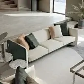 Exclusive Turri Blossom sofa with soft lines, parabolic arches and dark green accents in light-colored textile with a smooth matte finish