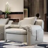 Distinctive Turri Eclipse lounge chair with light gray leather cushioning and light gold metal accents