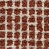 Terracotta textile pattern features a grid of looped-pile squares, creating a raised, floral texture against an off-white woven background.