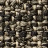 Dense tweed-like fabric texture features charcoal gray and off-white beige yarns in an irregular, nubby weave with a heathered, speckled pattern.