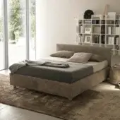 Exceptional Bolzan Letti bed with balanced proportions and soft surfaces wrapped in muted brown textile and crafted with a firwood structure