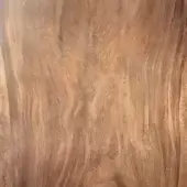Heritage walnut wood slab displaying ribbon grain patterns in brown and tan tones, with a central vertical split and matte finish.