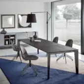 Elegant Bontempi Cruz extendable table with dark textured wood tabletop and glossy metal supporting legs