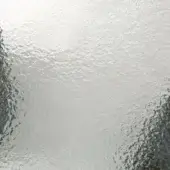 Hammered glass texture displaying mottled silver-grey tones, with uneven indentations and raised areas creating a reflective, tactile surface.