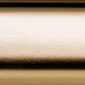 Satin brass metal texture displaying a gradient from golden to shadowed tones, with fine linear scratches and a polished, lustrous sheen.