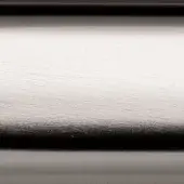Satin chrome metal surface with brushed texture, divided by two black horizontal bands, displaying a gradient from bright to dark tones.