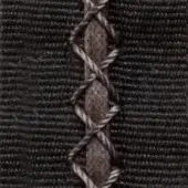 Dark gray woven fabric with a vertical brown two-tone twisted braid, exhibiting hand-stitched looping and knotting details; text visible at top.
