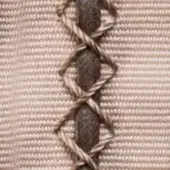 Braided cord detail on beige woven fabric, featuring dark and light brown twisted strands in a crisscross knot pattern.