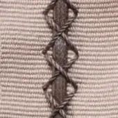 Beige fabric texture with vertical twisted cord stitch in a repeating crisscross pattern, displaying “borzalino > trap > trap combinations” text.