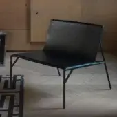 Distinguished Horm Tout Le Jour lounge chair crafted in black leather with a sleek angular metal silhouette