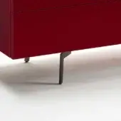 Red lacquered cabinet with two drawers, recessed pulls, and angled dark gray metal T-legs on a light gray background.