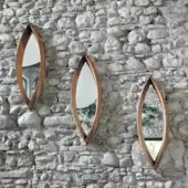 Distinguished Horm Mamanonmama mirror with black-willow solid wood and elongated oval shape crafted in Italy with a smooth finish
