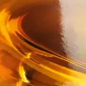 Ambra amber glass surface displaying swirling translucent orange-brown patterns, flowing lines, and a glossy, undulating texture from miniforms.
