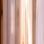 Copper rame dishes stacked vertically, displaying brushed metal texture and warm reddish-brown tones with a blurred, streaky effect.