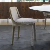 Distinguished Casamania Lepel chair upholstered in premium fabric with swirling gray patterns and a lighter beige spoon-like backrest finish