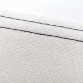 Off-white canvas fabric detail with a diagonal double-stitched seam in black thread, displaying a tight woven texture and clean construction.