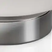 Chrome table lamp base, curved cylindrical shape, with polished metal and a matte white upper section, studio lighting.