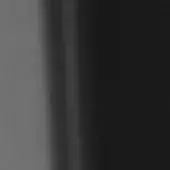 Grayscale gradient transitions from light gray to black, divided by a vertical band; smooth, uniform surface with minimalist, abstract composition.