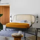 Elegant Miniforms Shiko Wien bed crafted with wood and woven cane, featuring a matte black finish and rounded headboard