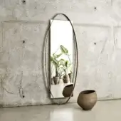 Exclusive Frag Twin Mirror with elongated oval metal profile and matte bronze toned reflective surface