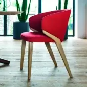 Handcrafted Bross Nora armchair with red fabric upholstery and a light-toned wood frame exhibiting curved lines and a smooth finish
