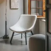 Lavish Lapalma Auki lounge chair with embracing lines upholstered in light textured textile and dark finished solid ash wood base