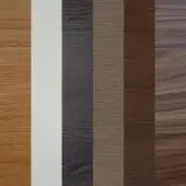 Wood veneer samples in linear arrangement showcasing light brown, white, gray, taupe, chocolate, and walnut tones against a white backdrop.