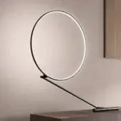Exceptional Kundalini Poise table lamp with matt black metallic diffuser and structure emitting cool white light