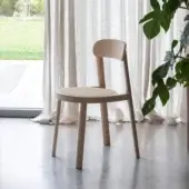 Elegant Miniforms Brulla chair built with light-toned wood and cane webbing showcasing curves with straight lines