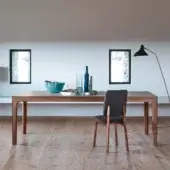 Distinguished Bross Gisa table with warm medium-toned wood and a smooth light-colored surface showcasing Italian craftsmanship