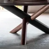 Round coffee table, dark brown wood top, starburst base with gray wood accents and four cylindrical legs.