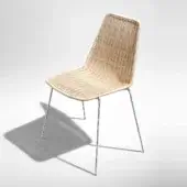 Handcrafted Casamania Sin chair with natural woven wicker seat and backrest built upon a chromed metal frame