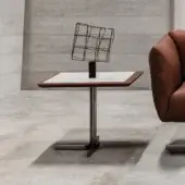 Distinguished Cierre1972 Laurel&Hardy side table with marble-effect ceramic top and rich leather edge built upon a slender metal base