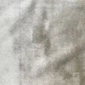 Gray beige velvet fabric texture with mottled shading and a dense short pile, displaying subtle light reflection and uniform surface.