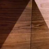 Walnut origami wood panels with diagonal arrangement, displaying dark and light brown tones, pronounced grain patterns, and textured surfaces.