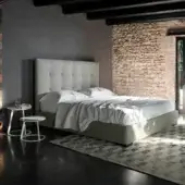 Distinguished Horm Grenada bed with tufted headboard and light gray upholstery built with solid beechwood feet in mocha lacquer finish