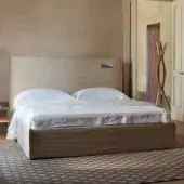 Superior Horm Tasca bed with light beige textile upholstery and white lacquered solid beechwood feet