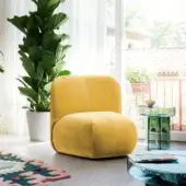 Exceptional Miniforms Boterina lounge chair in matte yellow textile with curved lines and a block aesthetic