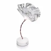 Table lamp with silver crinkled flower shade, red flexible stem, and white circular base, emitting diffused light in a studio setting.