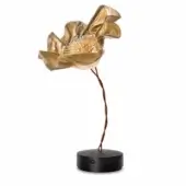 Flower table lamp, brushed gold metal, rippled petals with slender gold stamen, black circular base, flexible wire stem, studio lighting.