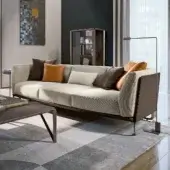 Lavish Turri Milano sofa with woven dark brown leather frame and plush cream textile seating accented with orange