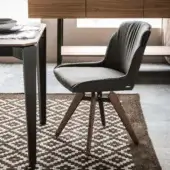Sophisticated Cattelan Italia Tyler chair with dark gray upholstery, dark brown stained ashwood legs and swivel return system