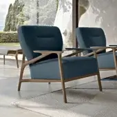 Elegant Turri Vine lounge chair with branched natural wood and cool-toned blue textile upholstery exhibiting a light finish